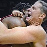 Arkansas coach Eric Musselman (right) hugs forward Kamani Johnson following a 72-71 victory over Kansas at the NCAA Tournament on Saturday, March 18, 2023, in Des Moines, Iowa.