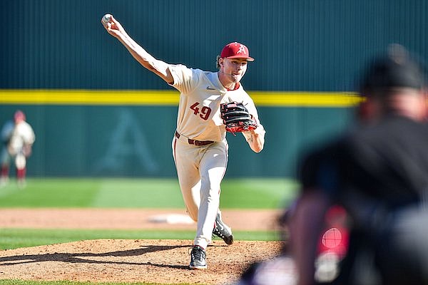 Arkansas relief pitcher Cody Adcock (49) delivers to the plate, Sunday, March 5, 2023, during the eighth inning of the Razorbacks’ 6-2 win over the Wright State Raiders at Baum-Walker Stadium in Fayetteville.