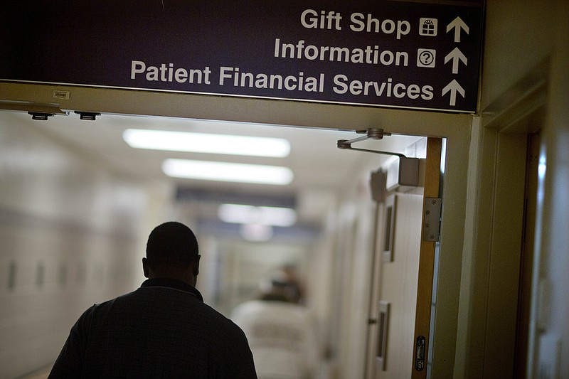A sign points visitors toward the financial services department at a hospital in this Jan. 24, 2014 file photo. Medicaid coverage will end for millions of Americans in 2023, and that pushes many into unfamiliar territory: the health insurance marketplace. (AP/David Goldman)
