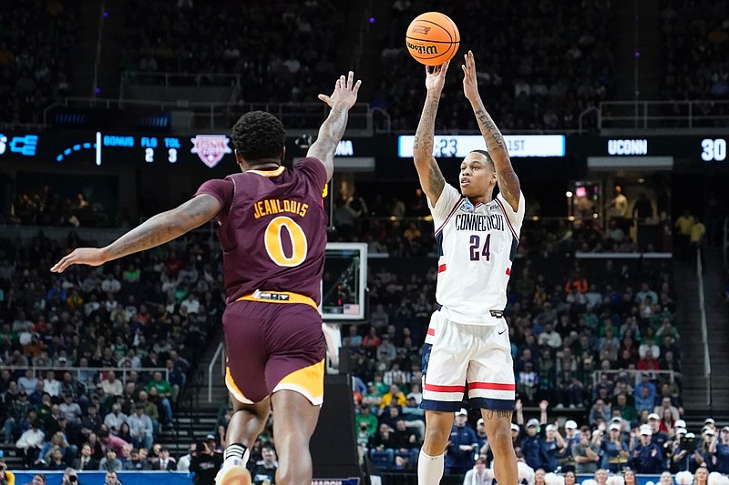 Connecticut's Jordan Hawkins (24) shoots over Iona's Berrick JeanLouis (0) in the first half of a first-round college basketball game in the NCAA Tournament, Friday, March 17, 2023, in Albany, N.Y. (AP Photo/John Minchillo)