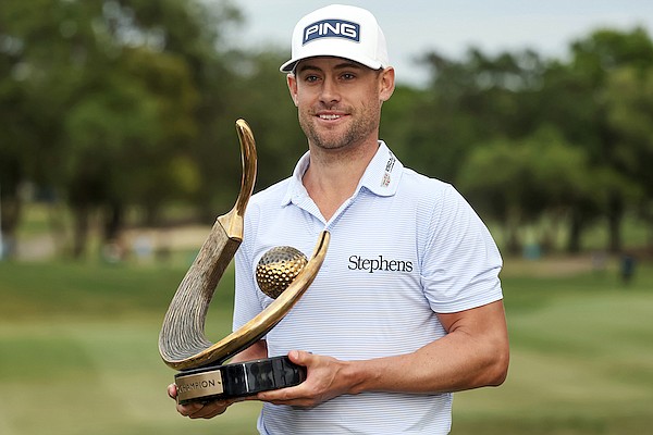 Taylor Moore holds the trophy after winning the Valspar Championship golf tournament Sunday, March 19, 2023, at Innisbrook in Palm Harbor, Fla. (AP Photo/Mike Carlson)