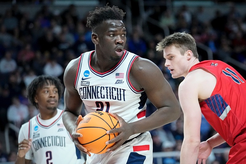 Connecticut's Adama Sanogo (21) looks to pass after rebounding against St. Mary's Mitchell Saxen (11) in the first half of a second-round college basketball game in the NCAA Tournament, Sunday, March 19, 2023, in Albany, N.Y. (AP Photo/John Minchillo)