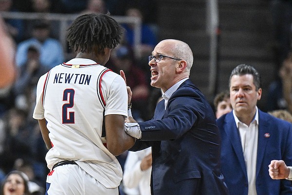 UConn guard Tristen Newton (2) listens to coach Dan Hurley during the first half of the team's second-round college basketball game against Saint Mary's in the men's NCAA Tournament on Sunday, March 19, 2023, in Albany, N.Y. (AP Photo/Hans Pennink)