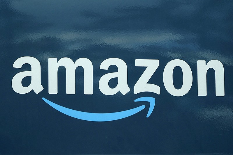 FILE - An Amazon logo appears on a delivery van, Oct. 1, 2020, in Boston. Amazon plans to eliminate 9,000 more jobs in the next few weeks, the company's CEO Andy Jassy said in a memo to staff on Monday, March 20, 2023. The job cuts would mark the second largest round of layoffs in the company's history, adding to the 18,000 employees the company said it would lay off in January. (AP Photo/Steven Senne, File)