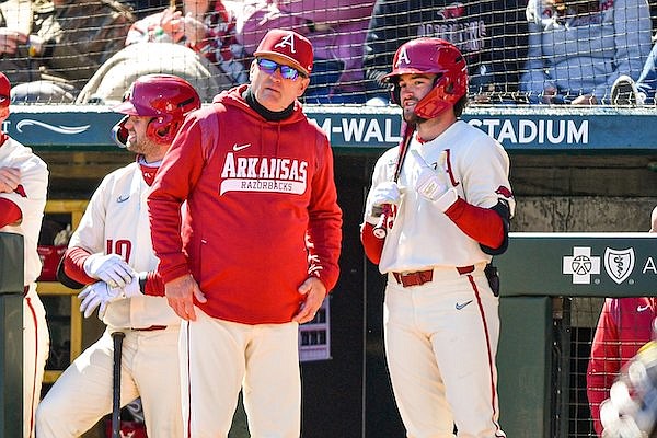 Arkansas head coach Dave Van Horn speaks with infielder John Bolton (9) before a bunt attempt on Sunday, March 19, 2023, during the fourth inning of the Razorbacks’ 5-0 win over Auburn at Baum-Walker Stadium in Fayetteville.