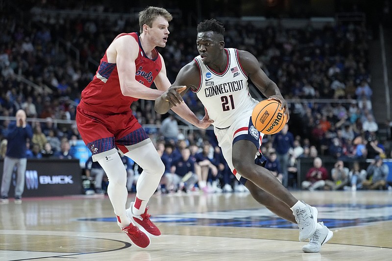 UConn's Adama Sanogo (21) drives against Saint Mary's Mitchell Saxen, left, in the second half of a second-round college basketball game in the NCAA Tournament, Sunday, March 19, 2023, in Albany, N.Y. (AP Photo/John Minchillo)