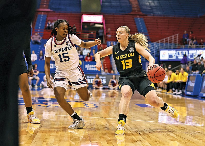 Missouri’s Haley Troup dribbles the ball alongside Zakiyah Franklin of Kansas during the first half of Monday night’s WNIT second-round game at Allen Fieldhouse in Lawrence, Kan. (Photo courtesy of Mizzou Athletics)