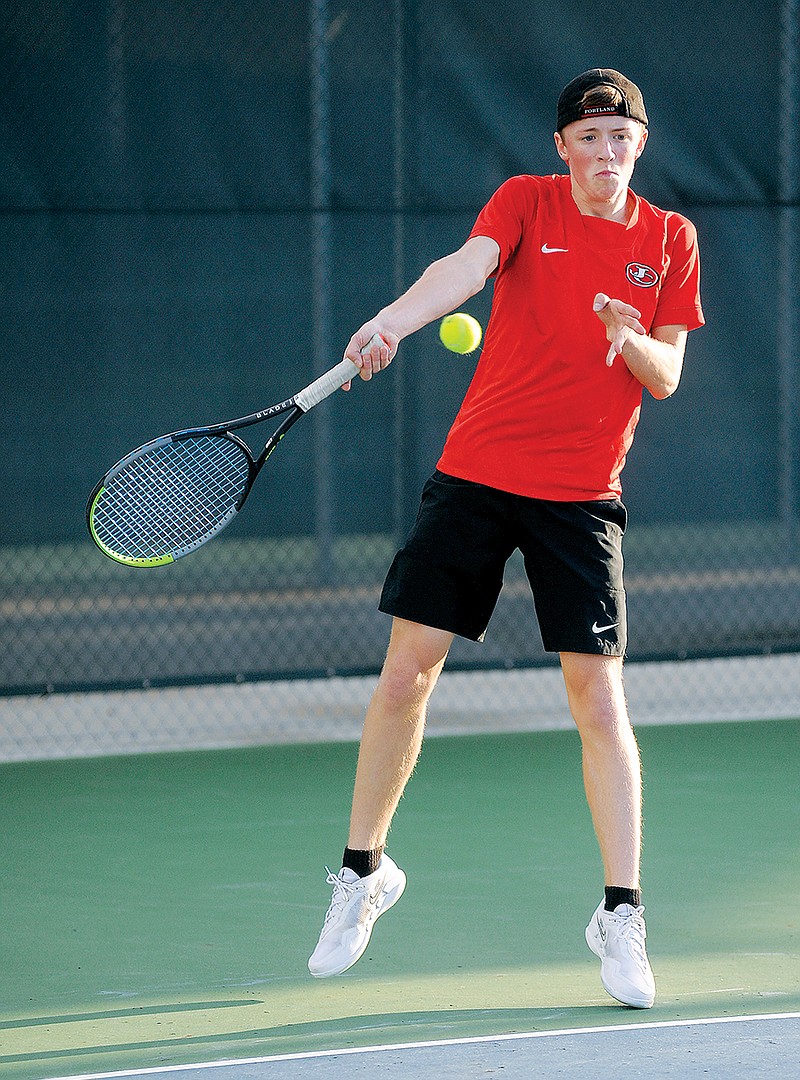 Jefferson City's Riley Cooper hits a return shot during a singles match last season against Helias at the Crusader Athletic Complex. (Shaun Zimmerman/News Tribune)