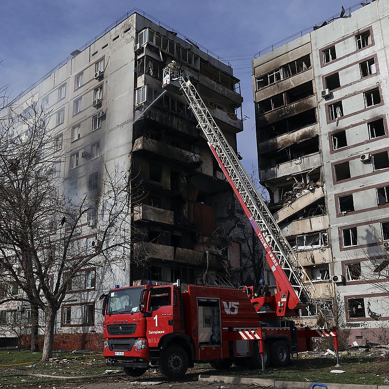 A firefighter responds Wednesday after a Russian missile hit an apartment building in the southeastern Ukrainian city of Zaporizhzhia. At least one person was killed, authorities said. More photos at arkansasonline.com/ukrainemonth13/.
(AP/Kateryna Klochko)