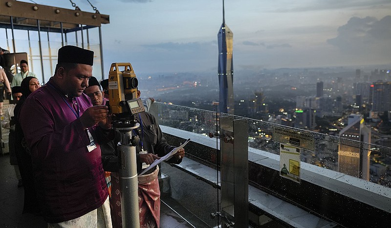 Members of the Malaysian Islamic authority perform the “Rukyah Hilal Ramadan” on Wednesday in Kuala Lumpur, Malaysia, sighting the new moon to determine the start of Ramadan.
(AP/Vincent Thian)