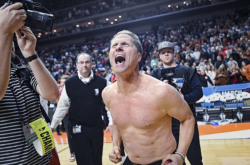 Arkansas Coach Eric Musselman celebrates after Saturday’s victory over Kansas in the second round of the NCAA Men’s Tournament. Taking off his shirt after big victories is something Musselman started doing when he was at the helm at Nevada.
(NWA Democrat-Gazette/Charlie Kaijo)