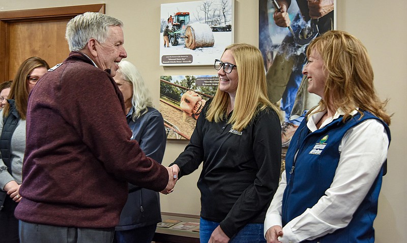 Missouri Gov. Mike Parson shakes hands with some Department of Agriculture employees Tuesday, March 21, 2023, after he presented a proclamation celebrating National Agriculture Week. (Julie Smith/News Tribune photo)