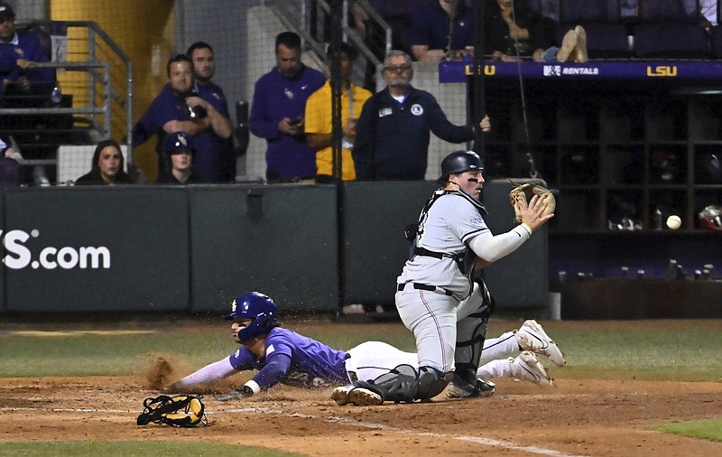 LSU’s Dylan Crews slides safely into home behind Samford catcher Kaden Dreier during their game at Baton Rouge. Crews leads the SEC in three offensive categories as one of the top returners this season for the top-ranked Tigers, who host the No. 3 Razorbacks for a three-game series beginning today.
(AP/The Advocate/Hilary Scheinuk)