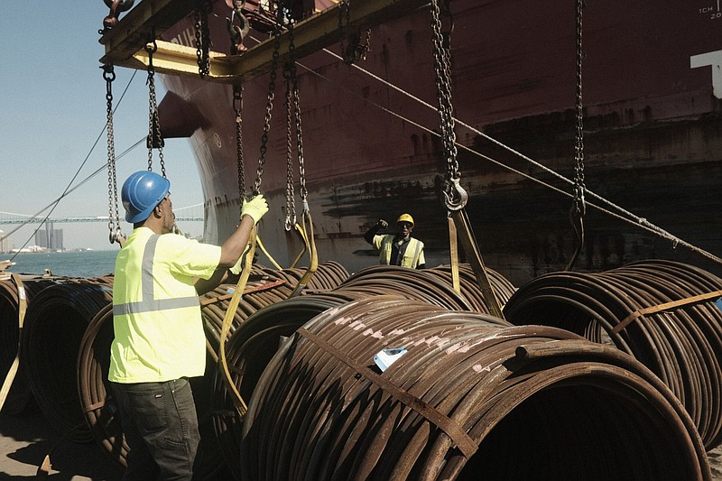 Workers unload bar-in-coil steel from a freight ship in the dockyard at the Port of Detroit in Detroit in 2021.
(Bloomberg News WPNS/Matthew Hatcher)