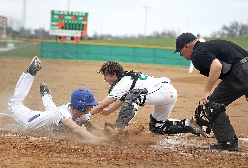 St. Francis Borgia’s Justin Mort slides into home plate safely ahead of the tag by Blair Oaks catcher Nolan Laughlin during the second inning of Wednesday’s game at the Falcon Athletic Complex in Wardsville. (Greg Jackson/News Tribune)