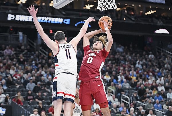 Arkansas guard Anthony Black (0) goes up for a shot against Connecticut forward Alex Karaban (11) during an NCAA Tournament game Thursday, March 23, 2023, in Las Vegas.