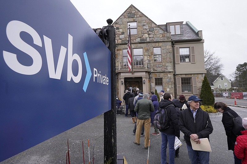 Customers and bystanders form a line outside a Silicon Valley Bank branch in Wellesley, Mass., after the bank’s March 10 collapse, the second-largest bank failure in U.S. history.
(Associated Press)