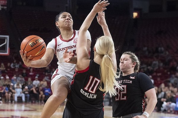 Arkansas' Chrissy Carr (34) goes up for a shot against Texas Tech defenders Bryn Gerlich (10) and Tatum Vietenheimer during a WNIT game Friday, March 24, 2023, in Fayetteville.