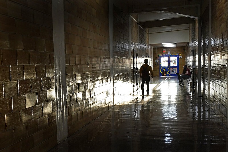 A student walks down a hallway between classes at a high school in Kansas City, Kan., on the first day of in-person learning in this March 30, 2021 file photo. According to a study by the Centers for Disease Control and Prevention released on March 31, 2022, nearly half of U.S. high school students said they felt persistently sad or hopeless during the covid-19 pandemic, and many teens said they suffered emotional or physical abuse by a parent or other adult in the home. (AP/Charlie Riedel)