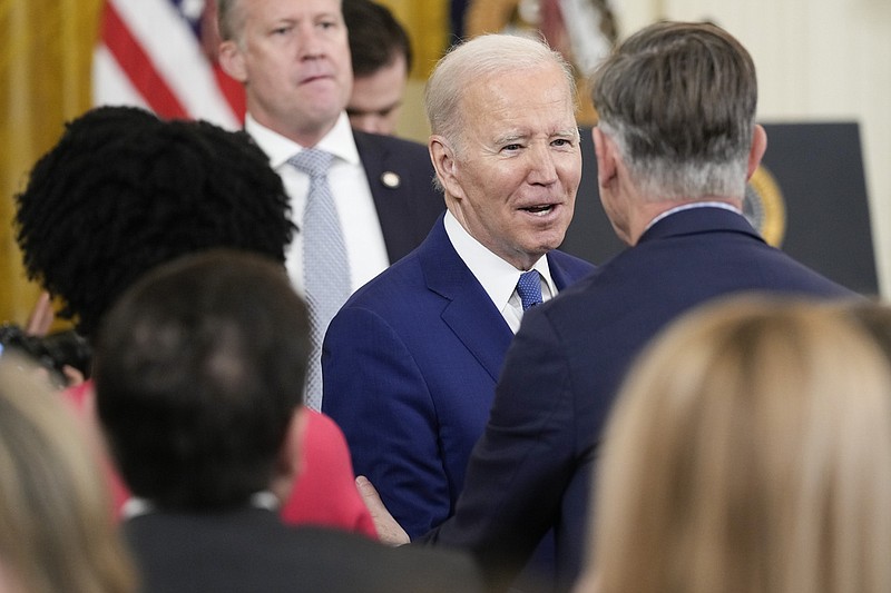President Joe Biden greets Rep. John Hickenlooper, D-Colo., after Biden spoke during an event in the East Room of the White House in Washington, Thursday, March 23, 2023, celebrating the 13th anniversary of the Affordable Care Act. (AP Photo/Susan Walsh)