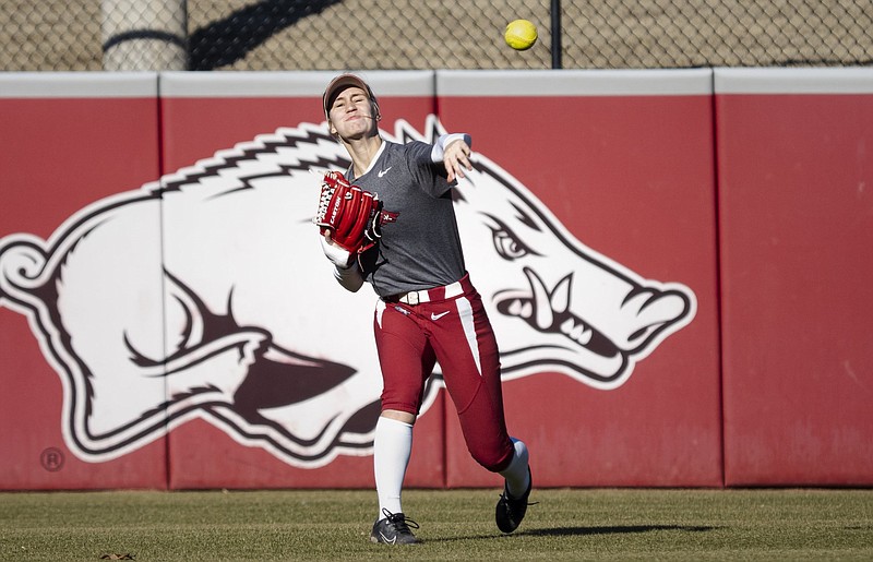 An Arkansas outfielder fields the ball during a softball practice at Bogle Park in Fayetteville in this Jan. 8, 2023 file photo. (NWA Democrat-Gazette/Charlie Kaijo)