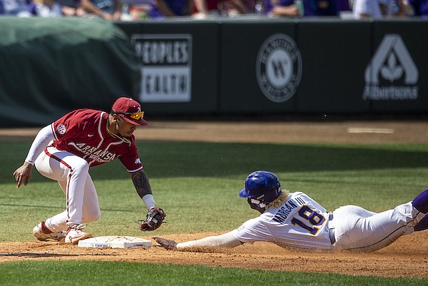 LSU first baseman Tre' Morgan (18) slides under the tag of Arkansas third baseman Harold Coll (1) in the sixth inning during the first game of an NCAA baseball doubleheader, Saturday, March 25, 2023 at Alex Box Stadium in Baton Rouge, La. (Michael Johnson/The Advocate via AP)