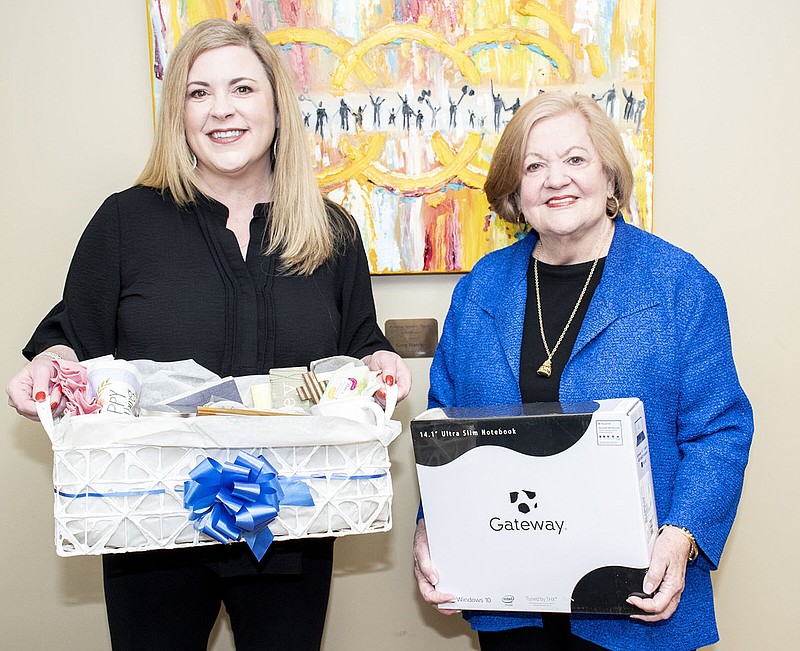 Allison Cox and her mother, Montine McNulty, hold items that will be a part of an auction at the April 15 Evolve Gala for Centers for Youth and Families. The theme of the event “Be a Bridge,” inspired by a children’s book of the same name.
(Arkansas Democrat-Gazette/Cary Jenkins)