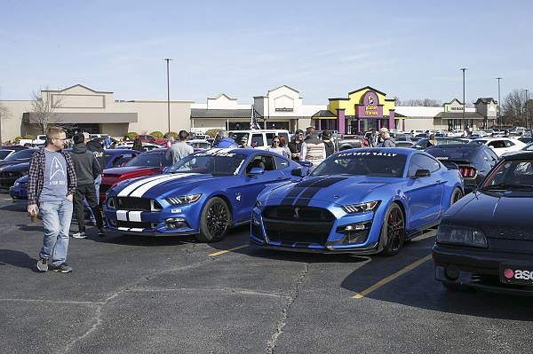 Attendees look at cars March 7, 2021, at the Frisco Station Mall parking lot in Rogers. Frisco Station LLC, which operates the Frisco Station Mall, has objected to plans to lease space to K1 Speed at an adjacent building at 2111 W. Walnut St. 
(File Photo/NWA Democrat-Gazette/Charlie Kaijo)