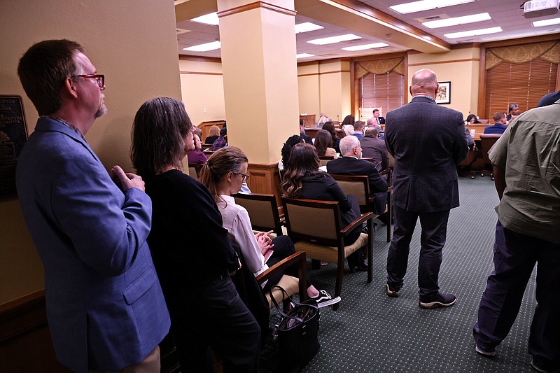 Members of the public stand in the back of room 149 at the Arkansas state Capitol to monitor a standing-room only House Committee on Judiciary meeting Tuesday, March 28, 2023. (Arkansas Democrat-Gazette/Colin Murphey)