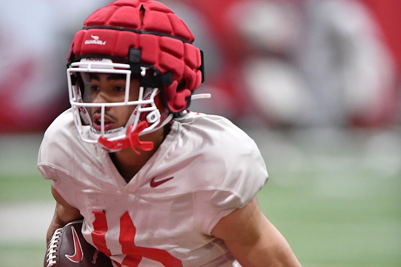 Arkansas receiver Isaiah Sategna carries the ball Thursday, March 16, 2023, after making a catch during practice inside the Willard and Pat Walker Pavilion in Fayetteville. Visit nwaonline.com/photo for the photo gallery.