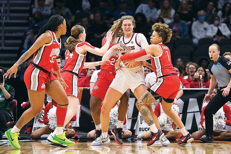 Virginia Tech center Elizabeth Kitley holds the ball as Ohio State players, including guard Taylor Mikesell and guard Rikki Harris (1), attempt to take it during Monday night’s game in Seattle. (Associated Press)