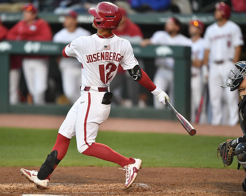 Arkansas center fielder Tavian Josenberger hits a 2-run home run Tuesday, March 28, 2023, to score shortstop John Bolton during the third inning of the Razorbacks’ win over Omaha at Baum-Walker Stadium in Fayetteville. Visit nwaonline.com/photo for today's photo gallery. .(NWA Democrat-Gazette/Andy Shupe)
