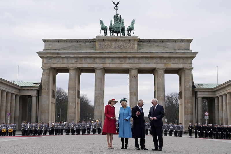 German President Frank-Walter Steinmeier (right) and his wife, Elke Budenbender, welcome Britain’s King Charles III and Camilla, the Queen Consort, in front of the Brandenburg Gate in Berlin on Wednesday. More photos at arkansasonline.com/330charles/.
(AP/Matthias Schrader)