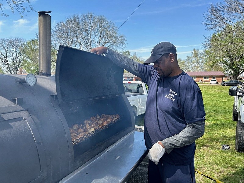 James Merritt of Tyson Foods in Pine Bluff grills chicken for residents of Rolling Fork, Miss., whose properties were damaged by an EF4 tornado Friday. (Special to The Commercial/Melissa Williams, Tyson Foods)