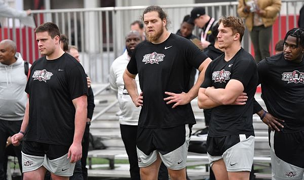 Arkansas offensive linemen Ricky Stromberg (from left), Dalton Wagner and linebacker Drew Sanders watch Wednesday, March 29, 2023, during Pro Day in the Walker Indoor Pavilion on the university campus in Fayetteville. Visit nwaonline.com/photo for today's photo gallery. ...(NWA Democrat-Gazette/Andy Shupe)