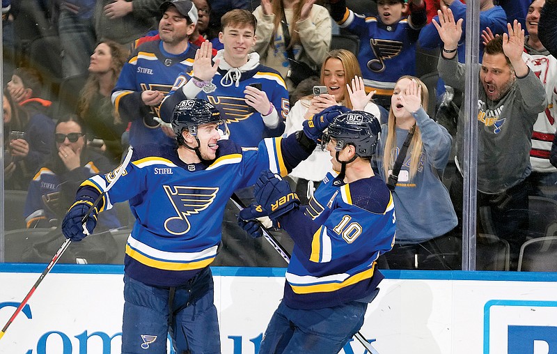 Jakub Vrana (left) is congratulated by Blues teammate Brayden Schenn after scoring the game-winning goal in overtime Tuesday night against the Canucks at Enterprise Center in St. Louis. (Associated Press)