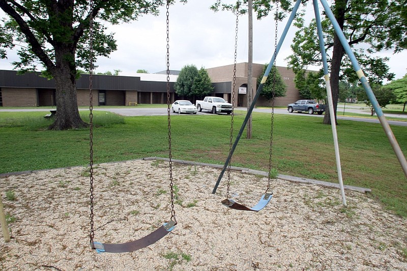 Swings are idle outside the former Arkansas City Community Schools in Arkansas City in this May 2009 file photo. The school district had consolidated with the McGehee School District in 2004, and the former school for students in grades K-12 reopened as the C.B. King Memorial Adult Center. (Arkansas Democrat-Gazette file photo)