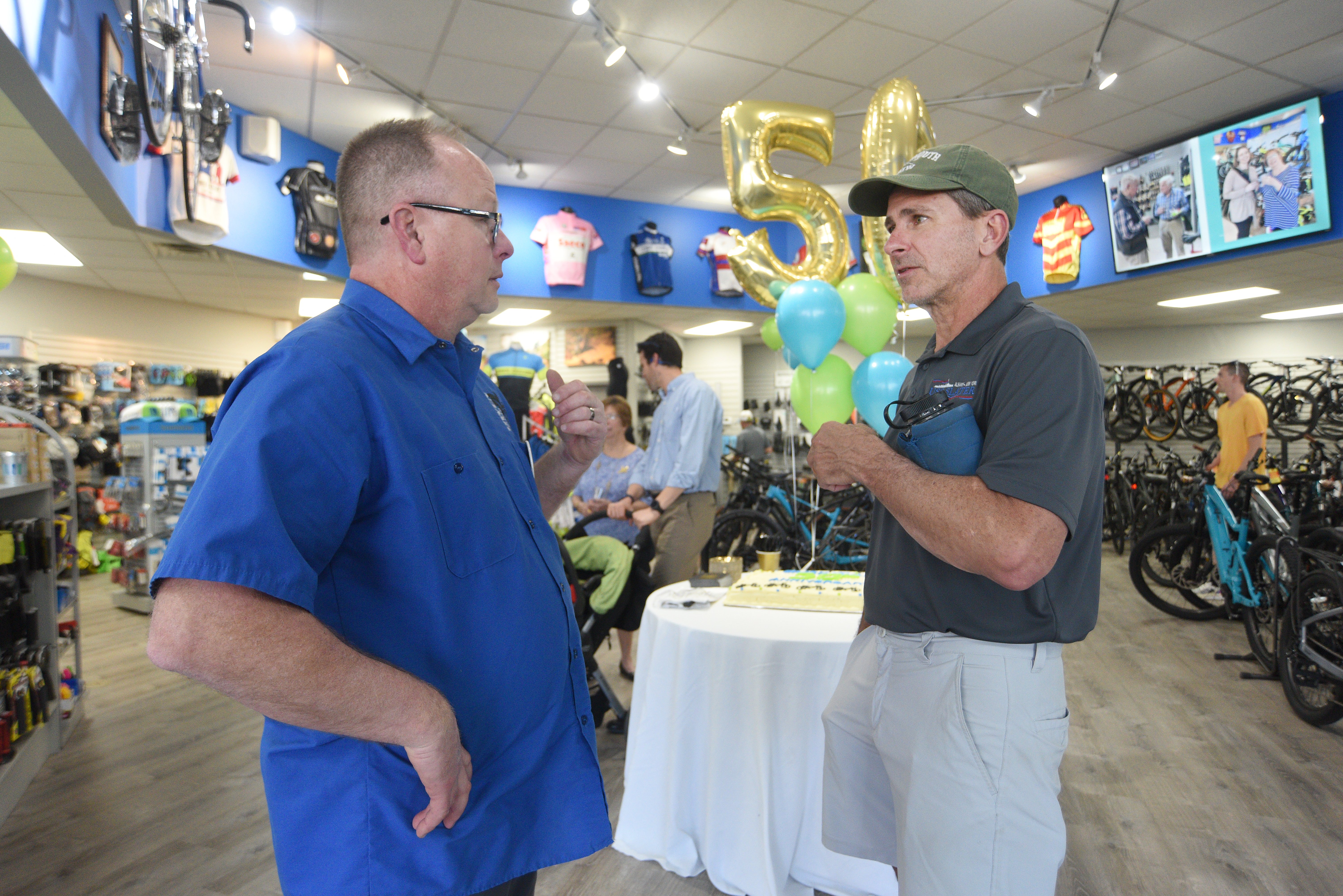 Staff photo by Matt Hamilton / Erik Hunt, left, owner of Owen Cyclery, talks with Soddy-Daisy resident Danny Smith during the 50 year celebration for Owen Cyclery in Hixson. on Thursday, March 30, 2023.
