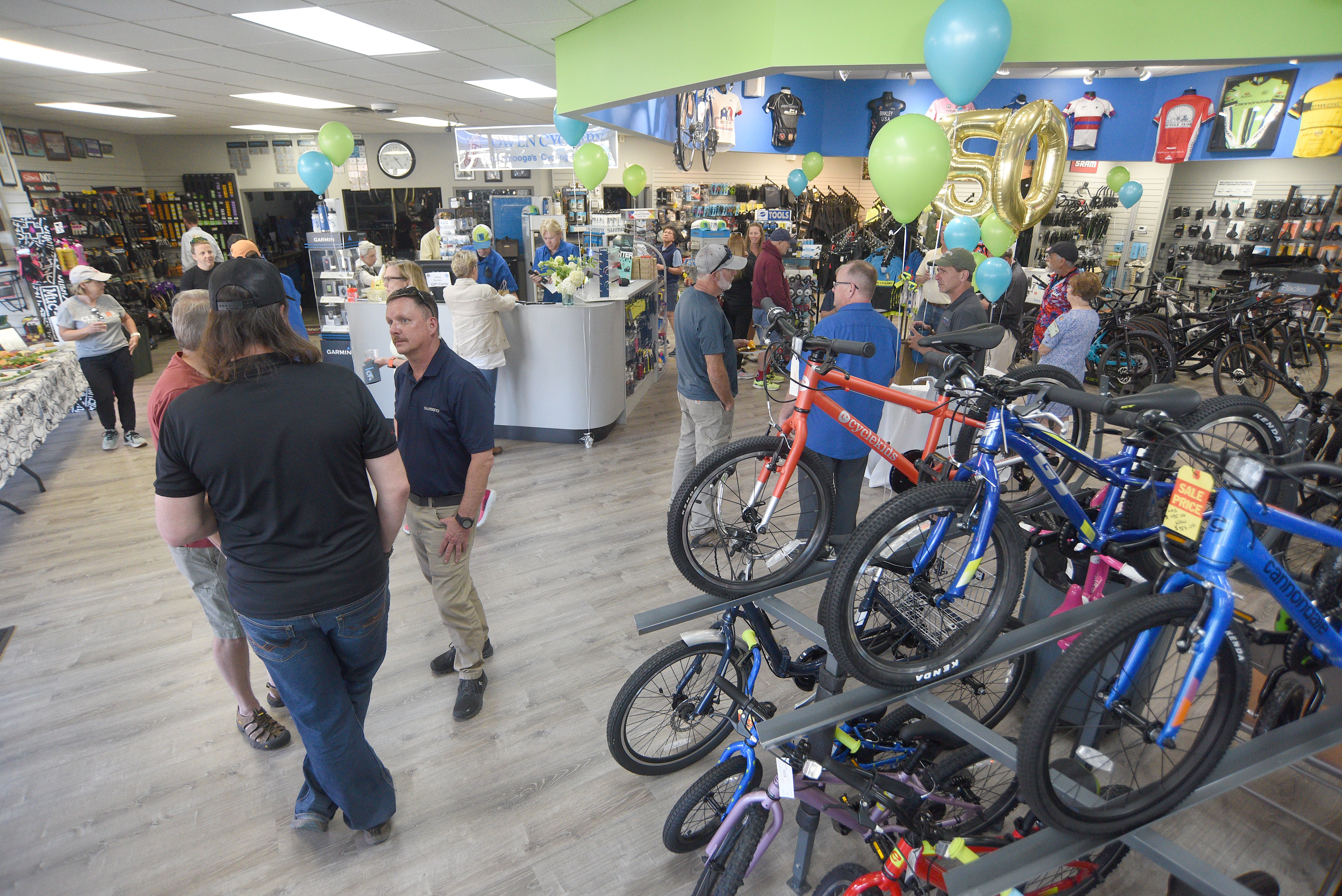 Staff photo by Matt Hamilton / Visitors enjoy the open house during the 50 year celebration for Owen Cyclery in Hixson. on Thursday, March 30, 2023.