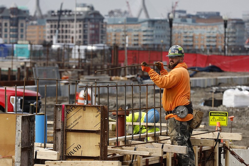 A construction worker prepares a recently poured foundation in Boston on March 17.
(AP/Michael Dwyer)