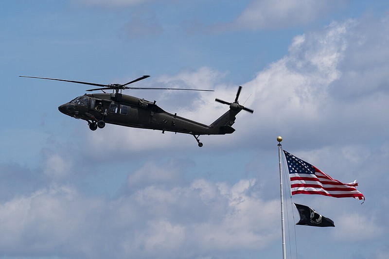 A UH-60 Black Hawk helicopter flies near the Pentagon, Thursday, May 19, 2022, in Washington. A military spokesperson said on Thursday, March 30, 2023 nine people were killed in a crash involving two Army Black Hawk helicopters in Kentucky. (AP Photo/Alex Brandon)