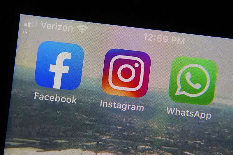 Mobile phone app logos for social media apps are photographed in New York in this Oct. 5, 2021 file photo. From left are Facebook, Instagram and WhatsApp. (AP/Richard Drew)