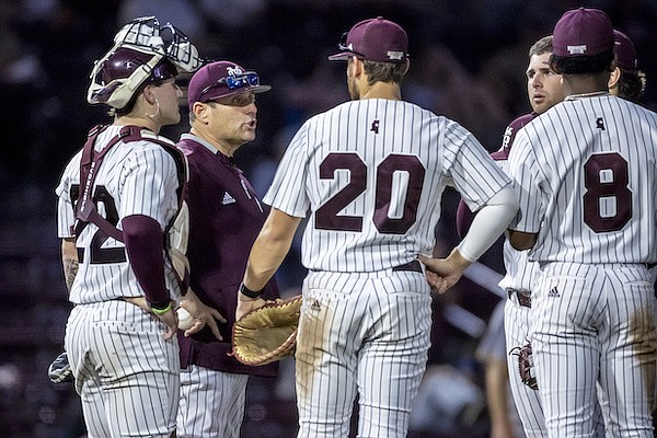 Mississippi State head coach Chris Lemonis talks with his infielders during a pitching change in an NCAA baseball game on Wednesday, Feb. 22, 2023, in Starkville, Miss. (AP Photo/Vasha Hunt)