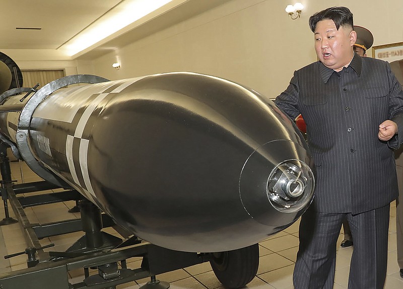 This photo provided on Tuesday, March 28, 2023, by the North Korean government, North Korean leader Kim Jong Un, rear, visits a hall displayed what appeared to be various types of warheads designed to be mounted on missiles or rocket launchers on March 27, 2023, in undisclosed location, North Korea. Independent journalists were not given access to cover the event depicted in this image distributed by the North Korean government. The content of this image is as provided and cannot be independently verified. (Korean Central News Agency/Korea News Service via AP)