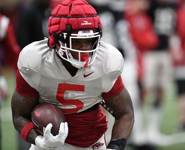 Arkansas running back Raheim Sanders carries the ball Thursday, March 16, 2023, during practice inside the Willard and Pat Walker Pavilion in Fayetteville. Visit nwaonline.com/photo for today's photo gallery. ...(NWA Democrat-Gazette/Andy Shupe)