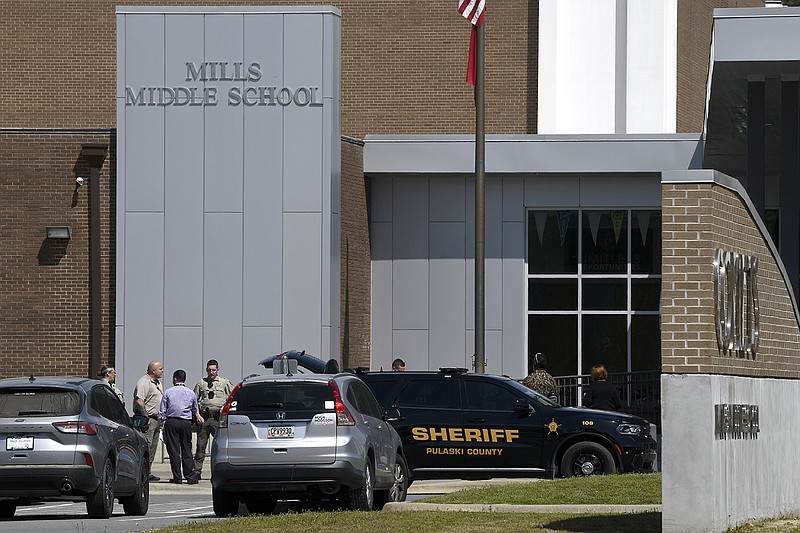 Law enforcement officers stand outside Mills Middle and Mills High schools near Little Rock. The schools were put on lockdown for roughly two hours on Thursday after two calls were made threatening a shooting.
(Arkansas Democrat-Gazette/Stephen Swofford)