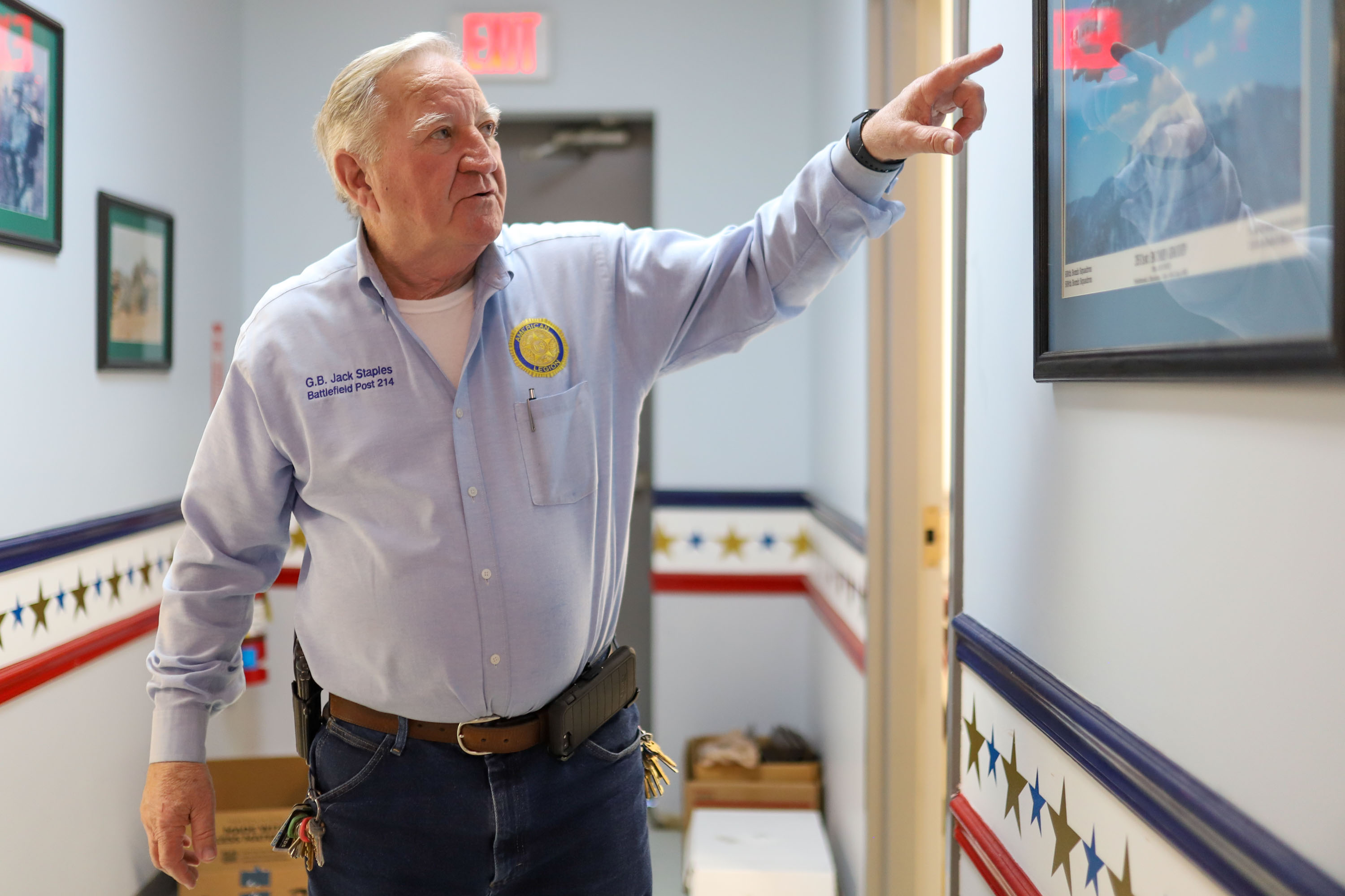 Staff photo by Olivia Ross / Jack Staples points to a poster with a B-17. The American Legion added a coffee shop, Legion Cafe, to its space as seen on Wednesday, March 29, 2023.