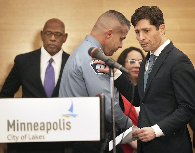 Minneapolis Mayor Jacob Frey (right) pats the shoulder of Minneapolis Police Chief Brian O’Hara on Friday in Minneapolis after O’ Hara spoke during a news conference announcing approval of a plan to rework policing that aims to reverse years of alleged systemic racial bias.
(AP/Star Tribune/David Joles)