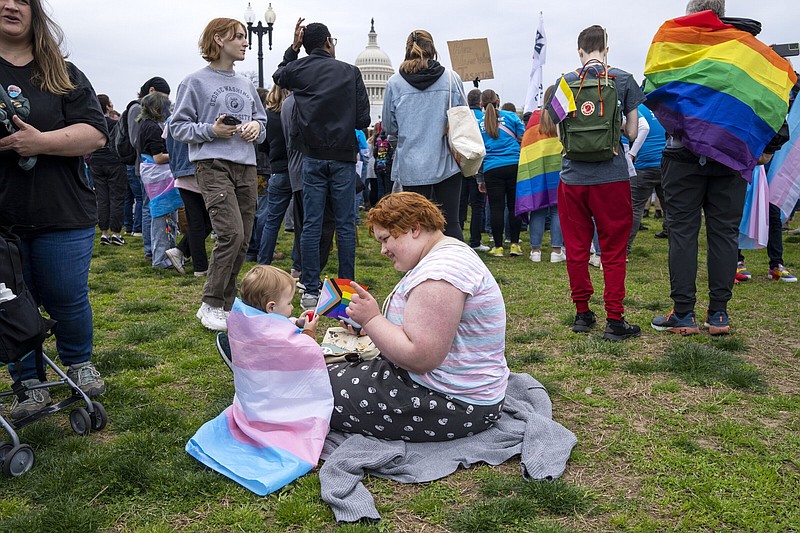 Leo (right) of Pennsylvania, plays with Alice, 2, while attending a rally as a part of Transgender Day of Visibility, Friday by the Capitol in Washington.
(AP/Jacquelyn Martin)