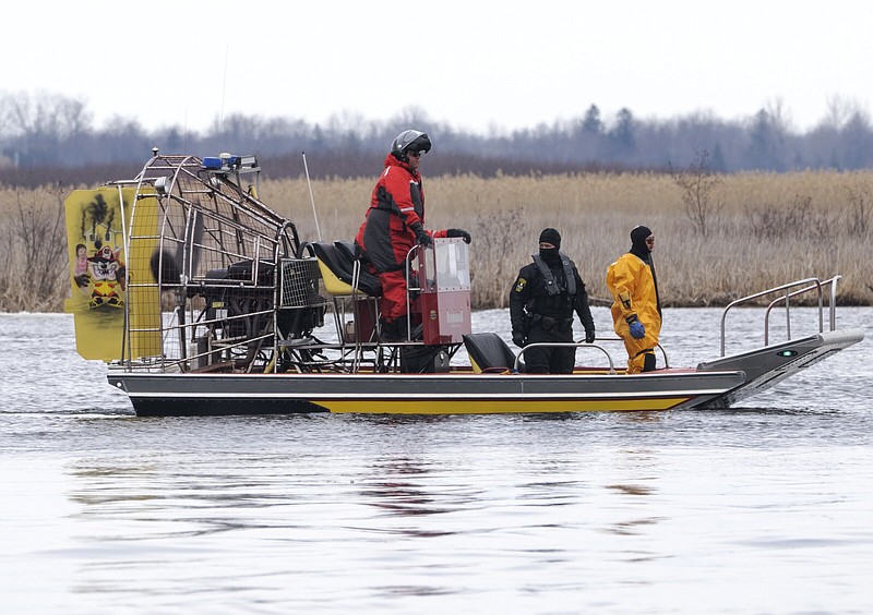 Searchers look for victims Friday in Akwesasne, Quebec.
(AP/The Canadian Press/Ryan Remiorz)